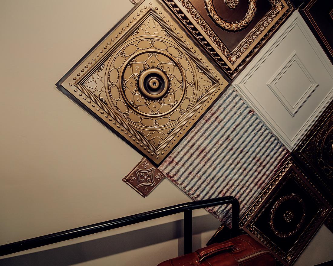 A detail of the salvaged pressed-tin ceiling panels overhead.